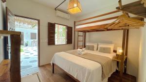 a bedroom with a large bed and a large window at Che Brazil Pousada in Cruz +29 photos