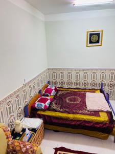 a bedroom with a bed in the corner of a room at Heritage House in Nizwa