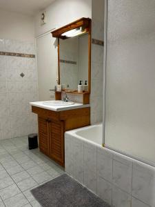 a bathroom with a tub and a sink and a mirror at Villa Airelle in La Turbie +17 photos