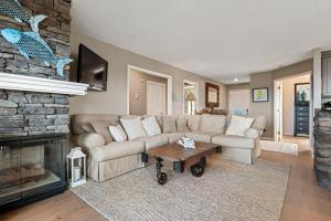 a living room with a couch and a fireplace at PC Beach in Manteo