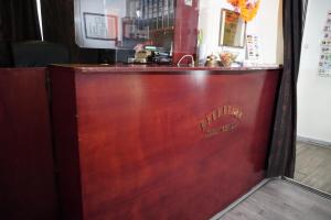 a wooden bar with the name of a restaurant at Hotel Schroder in Amsterdam