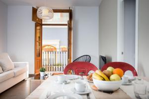 ein Wohnzimmer mit einem Tisch und einer Obstschale in der Unterkunft València Centre Torres de Quart in Valencia