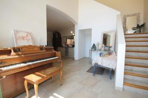 a living room with a piano and a staircase at Villa Évasion in Collioure