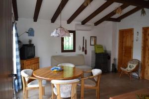 a living room with a wooden table and chairs at Panoramic lake view in Esparron-de-Verdon