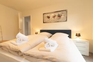 a bedroom with two beds with towels at Herz von Kellenhusen 8 - mit Sauna und Balkon, nur 300m vom Strand entfernt in Kellenhusen