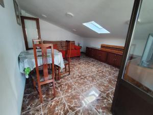 a room with a table and chairs and a couch at La Casa de Tito y Cosi in Noja +16 photos