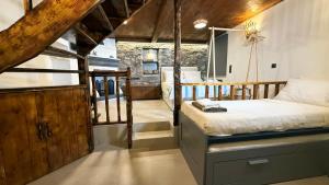 a bedroom with a bed in a room with wooden ceilings at Fevanti - Luxury Guest House in Skiathos Town