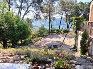 a backyard with a garden with flowers and trees at Panoramic lake view in Esparron-de-Verdon +12 photos
