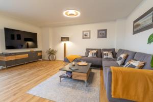 ein Wohnzimmer mit Sofa und Fernseher in der Unterkunft Herz von Kellenhusen 17 Dachterrasse, Sauna, besonders familienfreundlich in Kellenhusen