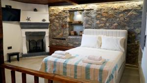 a bedroom with a bed with towels on it at Fevanti - Luxury Guest House in Skiathos Town