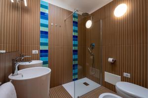 a bathroom with a shower and a toilet and a sink at AHR Residence Porto Pollo in Porto Pollo +42 photos