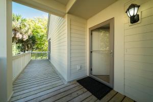 a porch of a home with a glass door at 778 Spinnaker Beach House in Seabrook Island