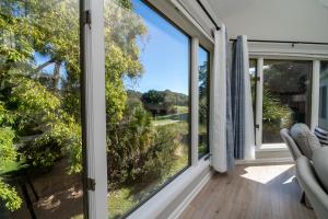 a view from the living room of a home with large windows at 778 Spinnaker Beach House in Seabrook Island