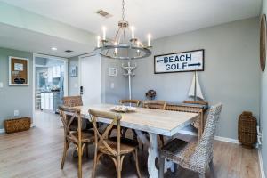 a dining room with a table and chairs at 778 Spinnaker Beach House in Seabrook Island +32 photos