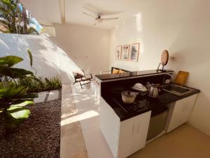 a kitchen with a sink and a counter top at La Belle Villa in Seminyak