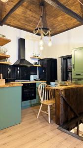 a kitchen with a wooden table and a wooden chair at Fevanti - Luxury Guest House in Skiathos Town +23 photos