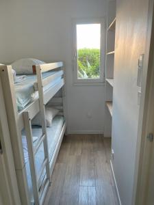 a small room with a bunk bed and a window at Studio Argelès sur Mer in Argelès-sur-Mer