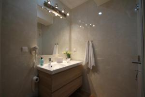 a bathroom with a sink and a mirror at Alfama Right Point in Lisbon +64 photos