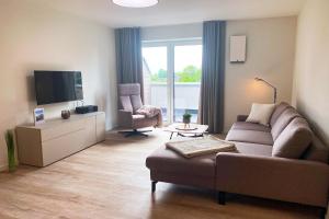 Μια τηλεόραση ή/και κέντρο ψυχαγωγίας στο KÜSTE33/44 - Neues Apartment mit Sauna in Strannähe