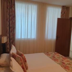 a bedroom with a bed and a large window at Apartment Sunset resort C8-24 in Pomorie +46 photos