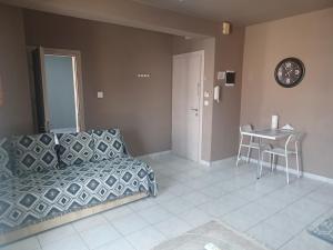 a living room with a couch and a table and a clock at Marinas Apartments Alexandroupolis in Alexandroupoli +35 photos