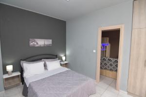 a bedroom with a large bed and a mirror at Marinas Apartments Alexandroupolis in Alexandroupoli