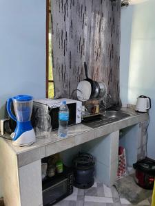 a kitchen counter with a sink and a counter top with a counter at MSF BACHELOR PAd in Arusha