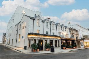 a large white building on the corner of a street at The Marcus Portrush, Tapestry Collection By Hilton in Portrush