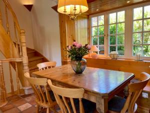 a dining room table with a vase of flowers on it at Sylt Glück in Morsum