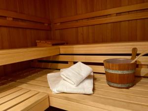 a sauna with two towels and a bucket at Sylt Glück in Morsum +25 photos