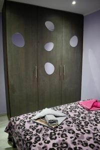 a bedroom with a bed with a black and white blanket at SkiathitissasMaison in Skiathos