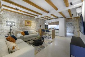 a living room with a couch and a table at Villa Mareta Cavtat in Cavtat