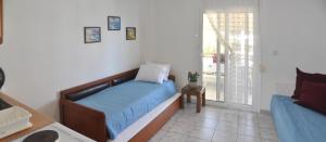 A bed or beds in a room at Agapi Apartments