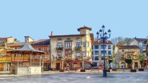 a group of buildings on a street with a light pole at La Tabernilla II in Ampuero