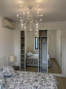 a bedroom with a ceiling fan and a large mirror at Sol Y Mar in Puerto del Carmen