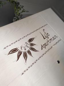 a table with a table cloth with a flower on it at Life Apartman in Makó +2 photos