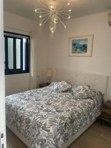 a bedroom with a bed and a ceiling fan at Sol Y Mar in Puerto del Carmen