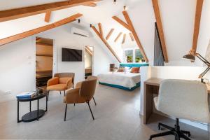 a bedroom with a bed and a desk and chairs at Villa Mareta Cavtat in Cavtat