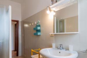 a bathroom with a sink and a mirror at L'Elicriso in Castiglione della Pescaia +23 photos