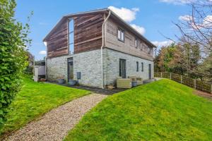 a large stone house with a gambrel roof at House 36 in Looe