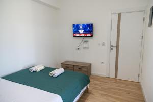 a bedroom with a bed and a flat screen tv at Odore di mare in Ulcinj