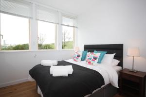 a bedroom with a large bed with pillows at House 47 in Talland +16 photos