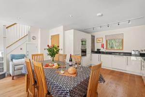 a kitchen and dining room with a table and chairs at House 5 in Looe