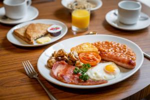 a plate of breakfast food on a wooden table at The Washington in Bristol