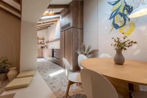 a dining room with a wooden table and white chairs at Maxima Comoda luxury villa in Dubrovnik +57 photos
