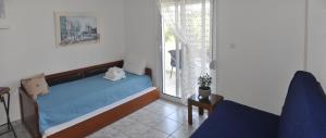 A bed or beds in a room at Agapi Apartments