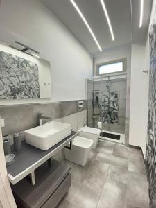 a bathroom with a sink and a toilet at Villa Alena in Montallegro +54 photos