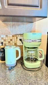 a green blender sitting on top of a counter at The Panatella Pad /Guest’s Private Suite in Calgary