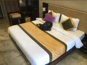 巴德里纳特Neem guest house的一张大床，上面放着一个背包