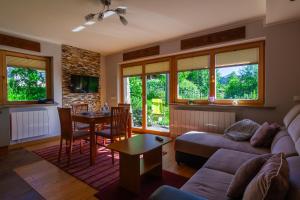 a living room with a couch and a table at Cyrhla przy szlaku in Zakopane